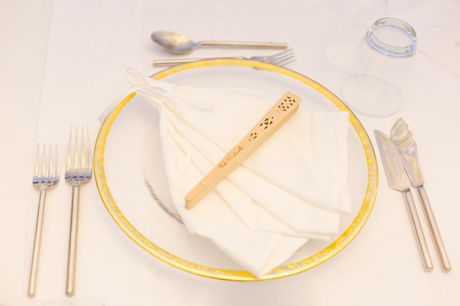 Elegant place setting with fan napkin and gold rim plate