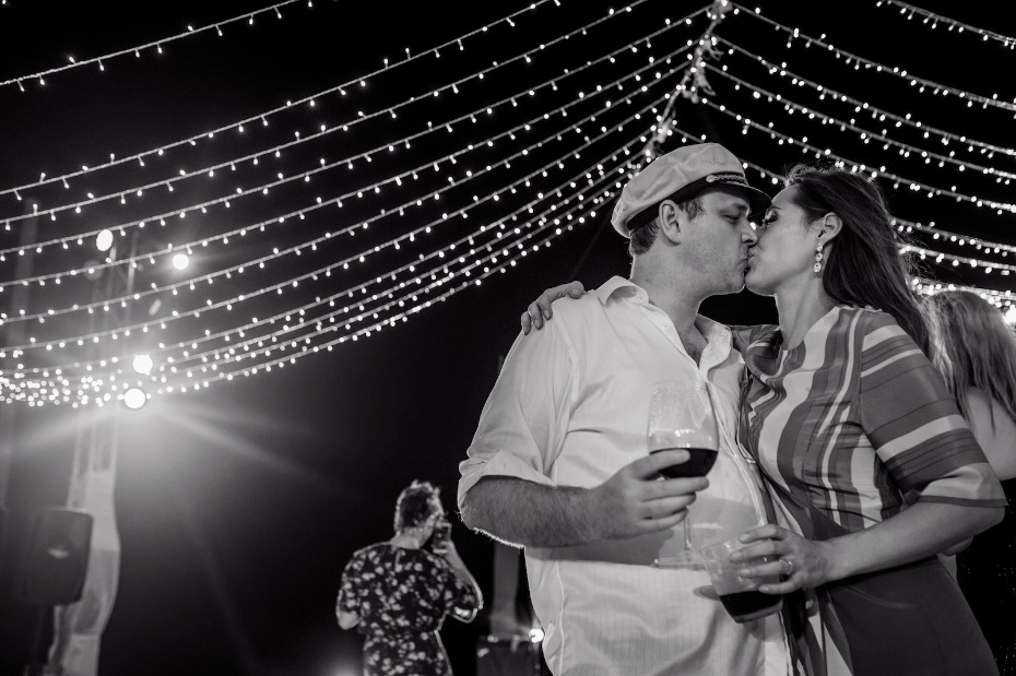 Black and white photo of couple kissing at night event