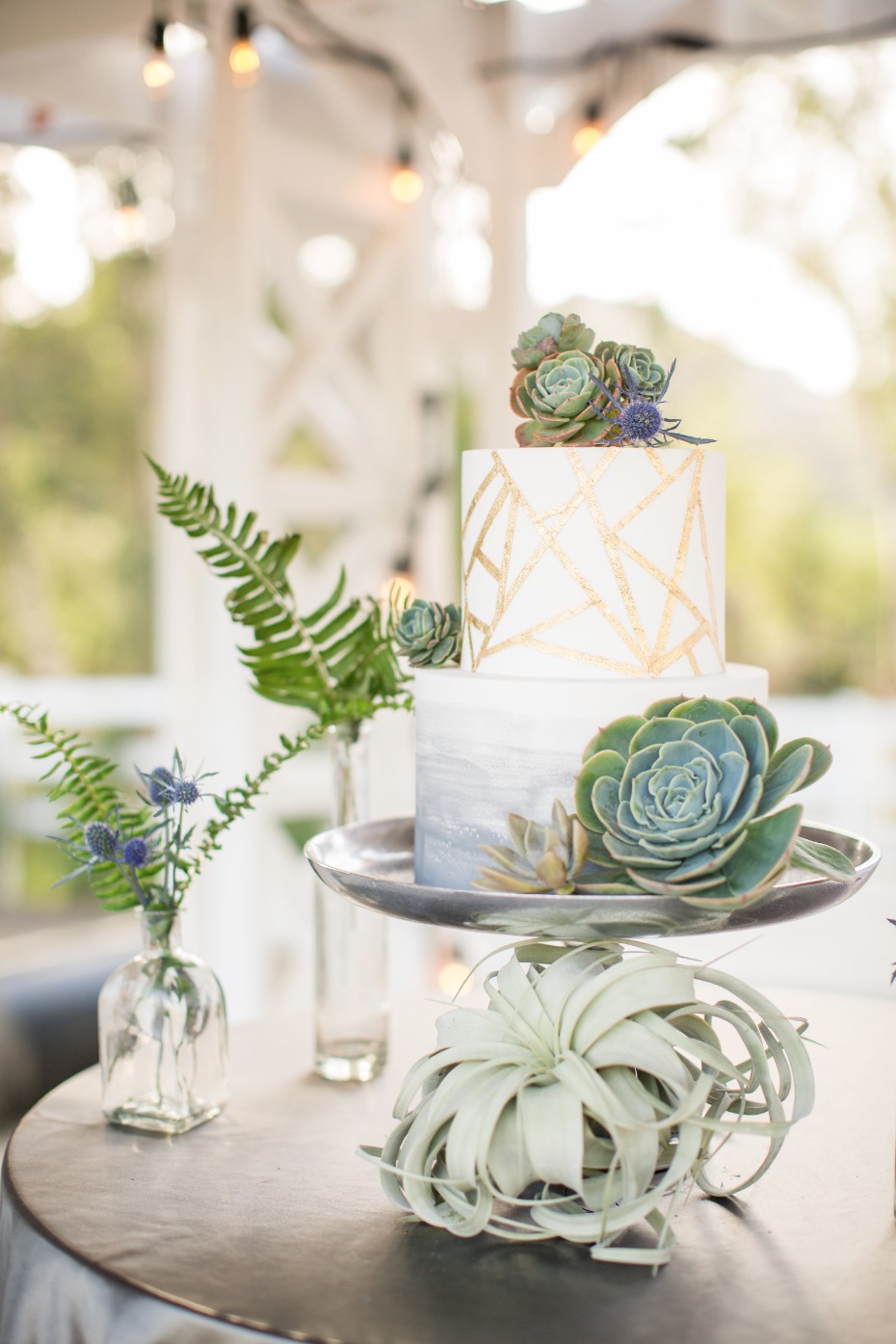 gold geometric wedding cake topped with succulents