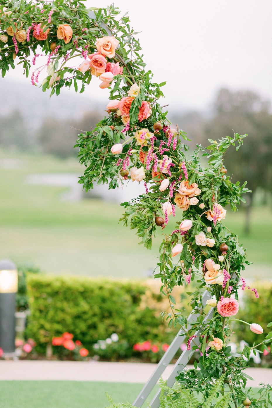 flower draped wedding arch