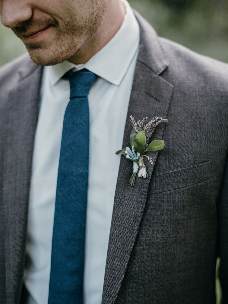 Blue tie and grey suit