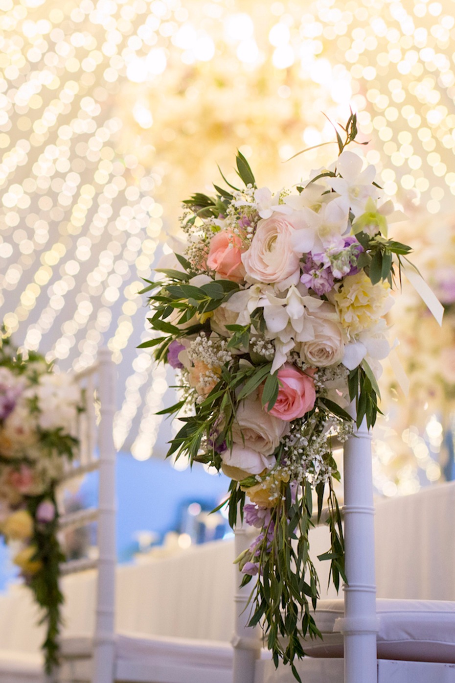 Elegant wedding chair decoration with floral arrangement
