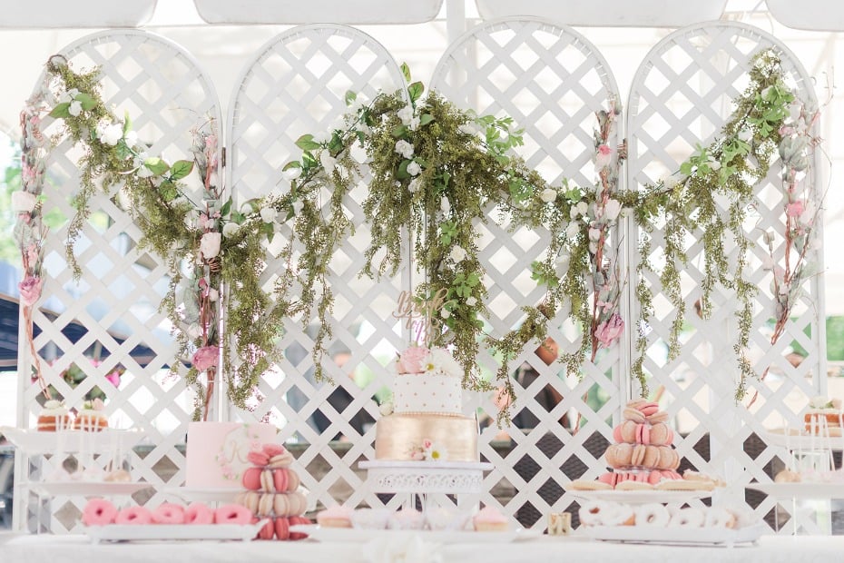 Gold blush and ivory cake table with greenery garland
