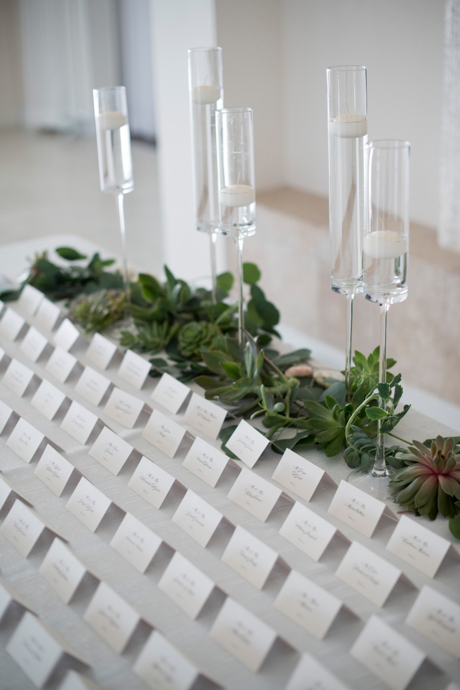 escort card table with succulent accents