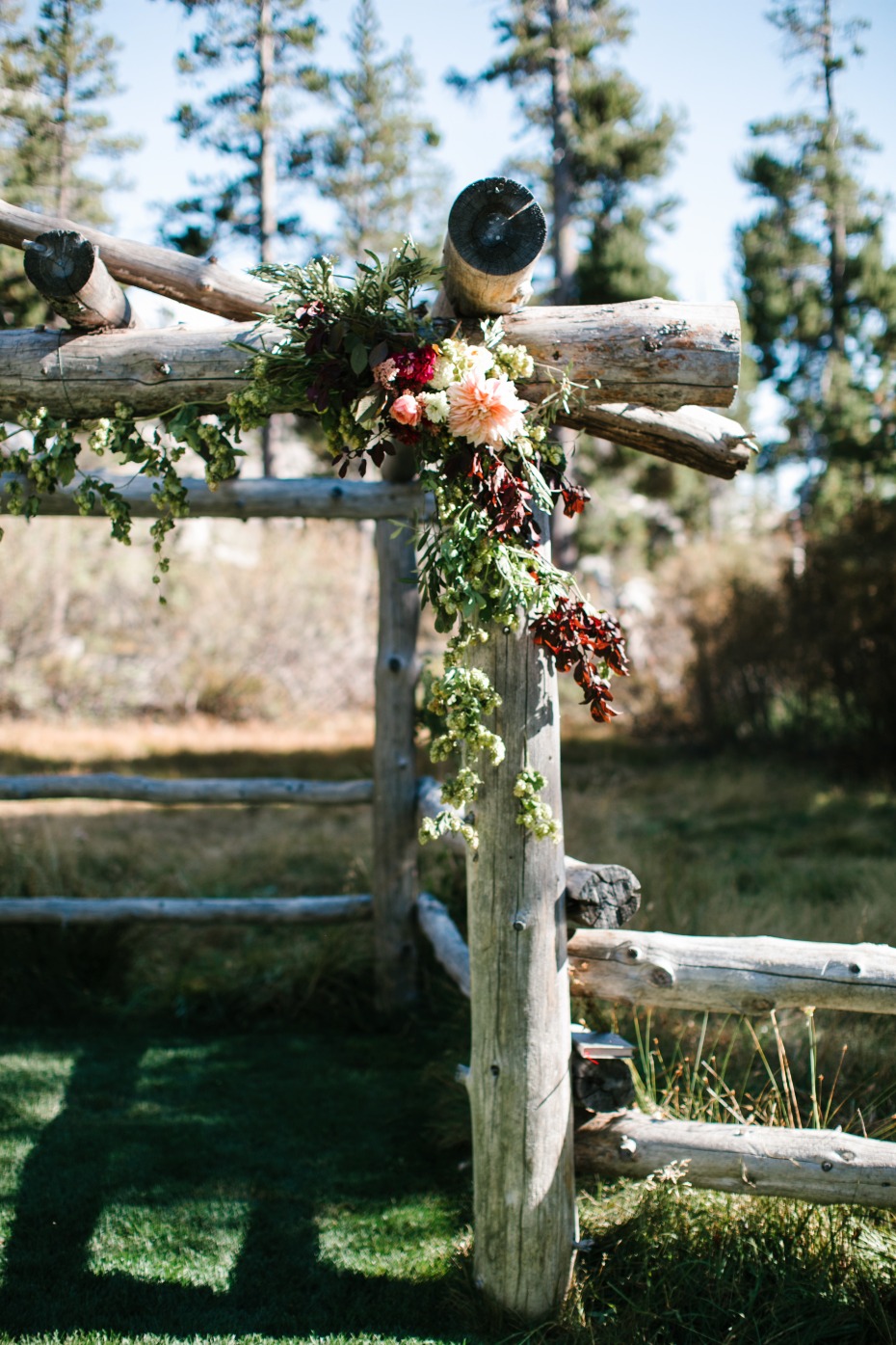 rustic flower accented wedding arch
