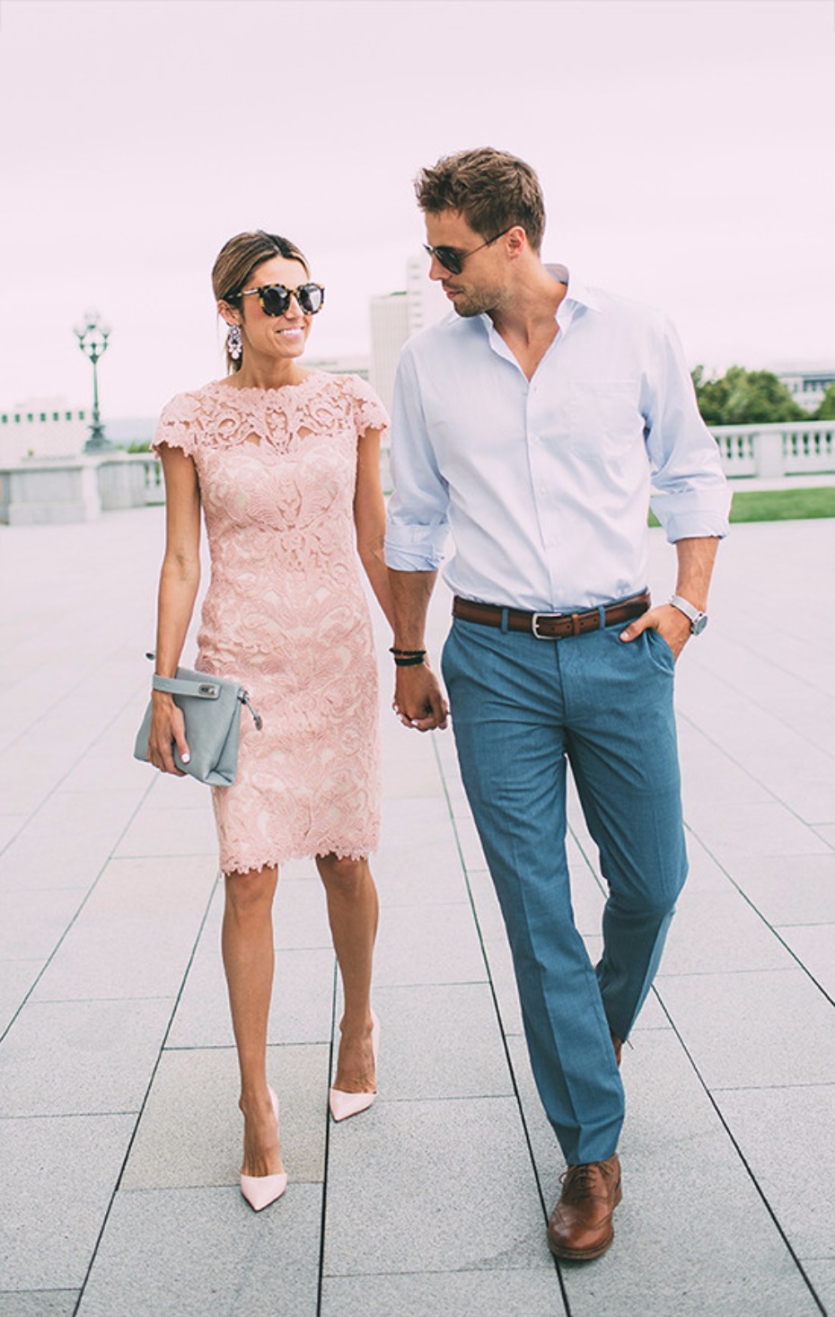 Couple stylishly dressed walking hand in hand outdoors