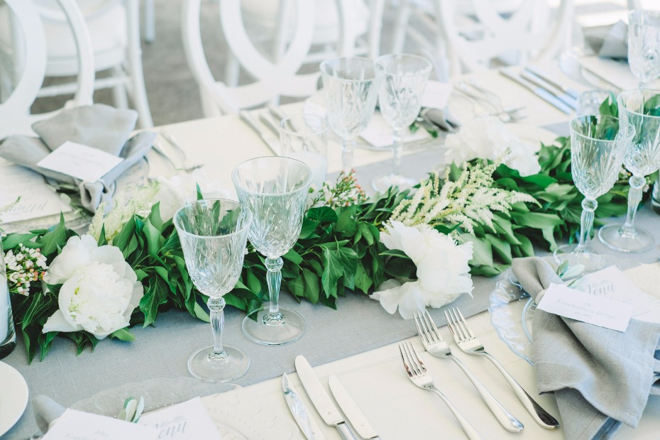 Elegant wedding table setting with floral arrangement and crystal glasses