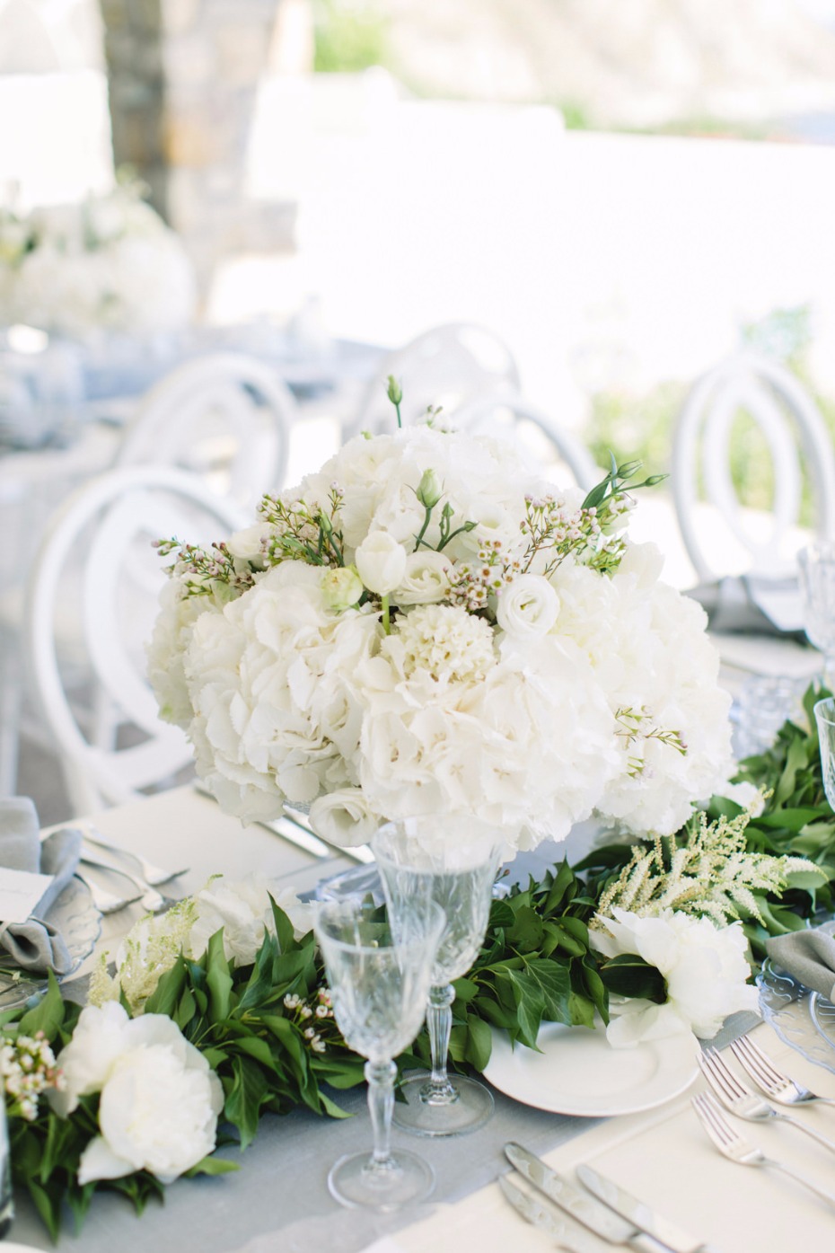 Elegant wedding table setting with white flowers and decor