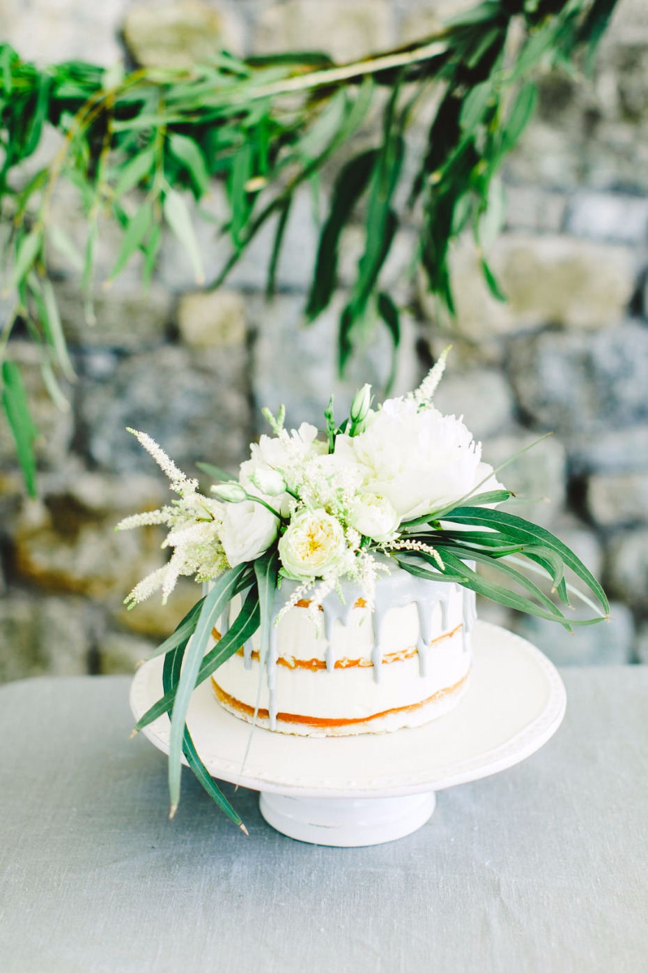 Elegant white cake with flowers on a cake stand for celebration