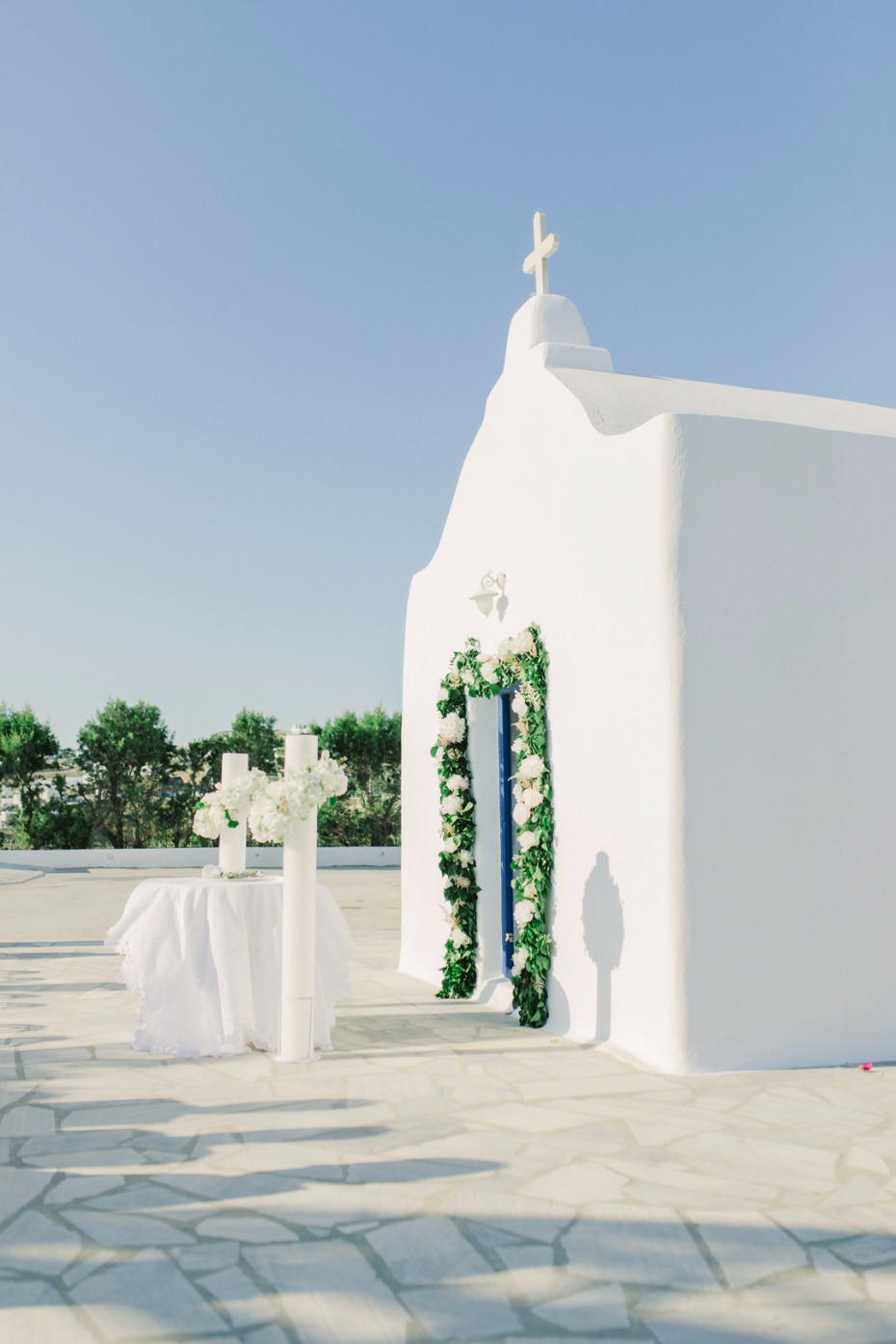 A beautiful white church decorated for a wedding ceremony outdoors