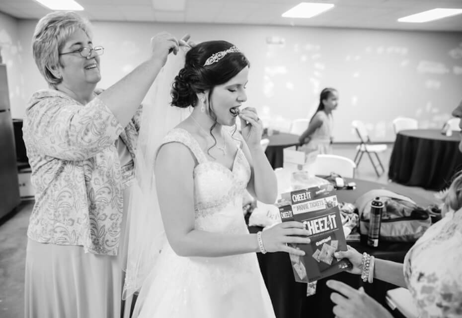 bride snacking in wedding dress