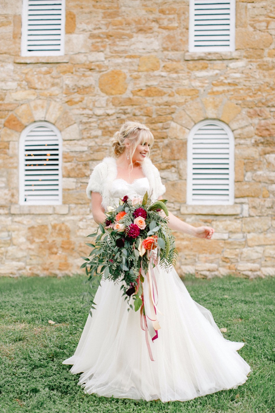 bride in white classic wedding dress with fall inspired bouquet