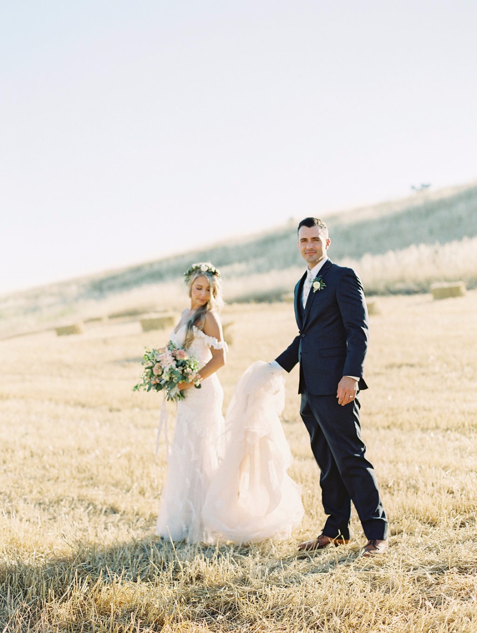 Bride and groom portrait in a hay field