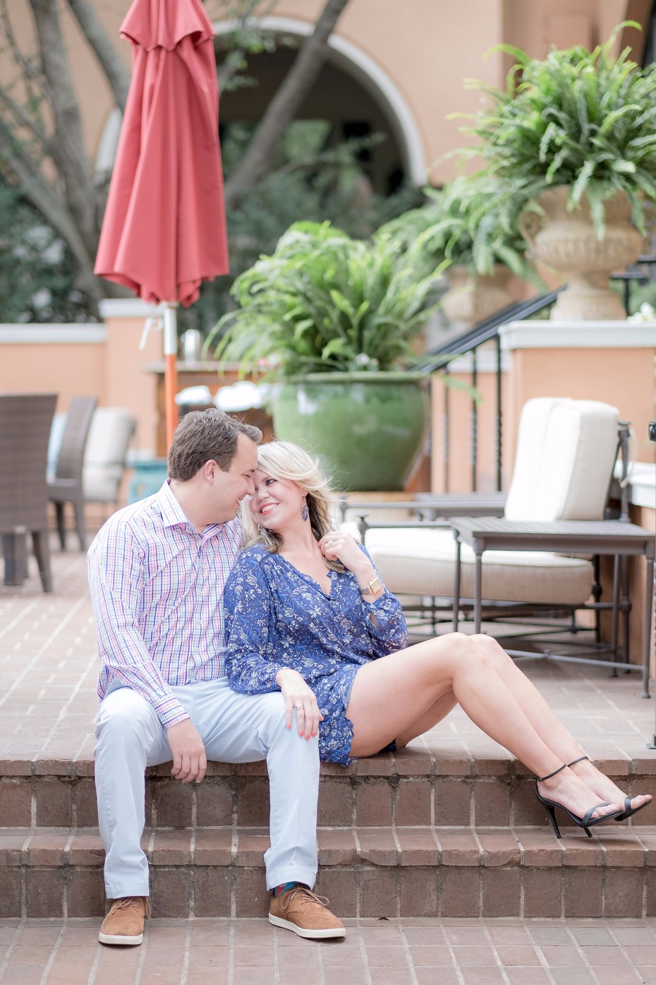 Happy couple embraces outdoors, romantic engagement photo