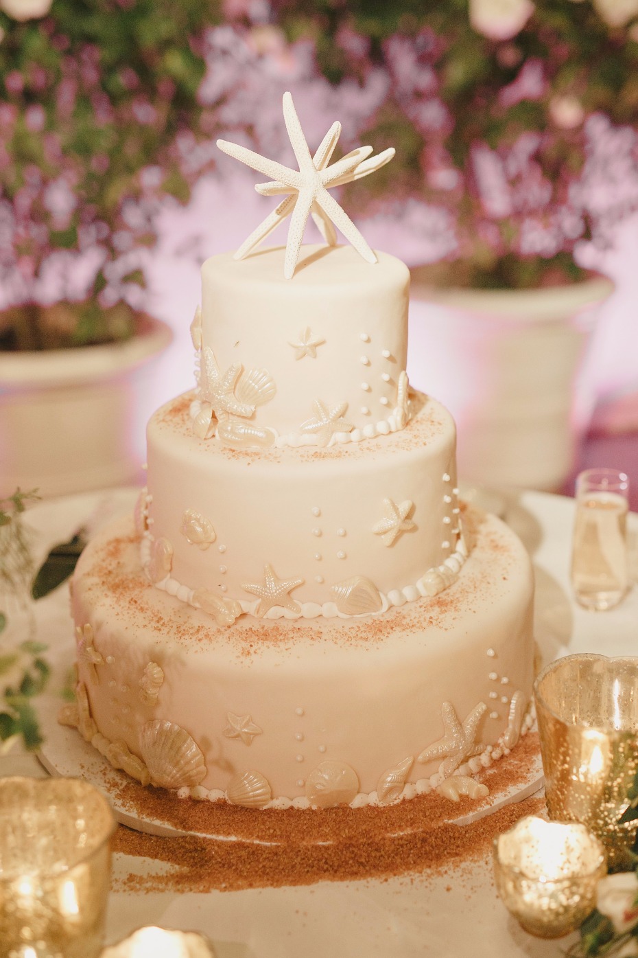 all white wedding cake with a subtle beach theme
