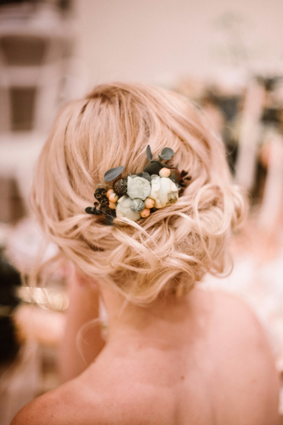 wedding hair updo with sweet floral accent