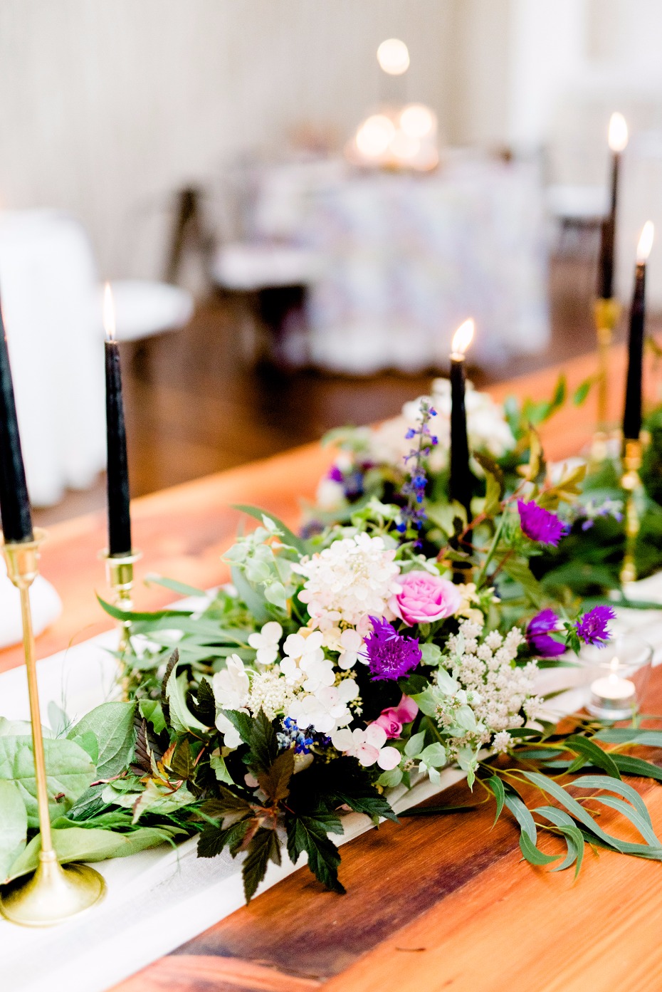 Purple and green centerpiece with black candles