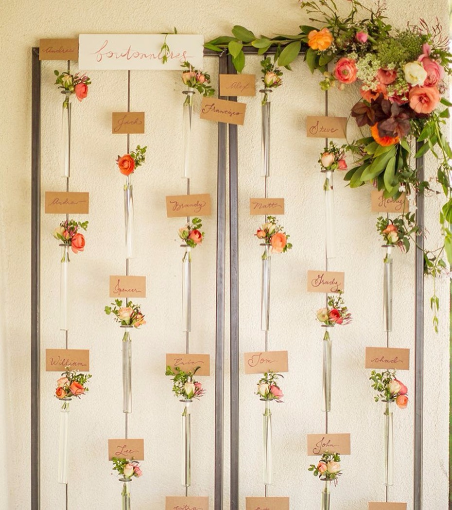 Wedding seating chart with floral arrangements in test tubes