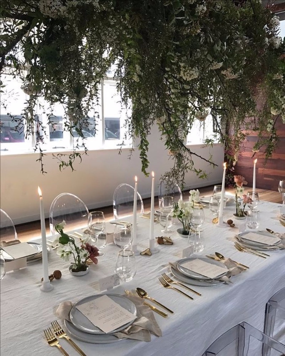 Elegant wedding table setting with candles and greenery