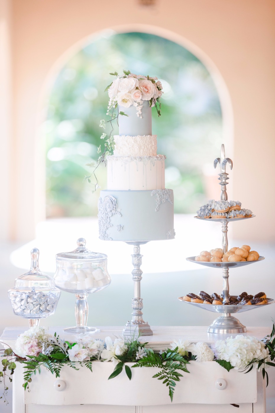 soft blue wedding cake with elegant dessert table