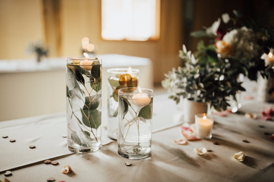 DIY different sized vases with leaves and floating candles