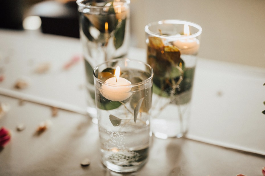 DIY different sized vases with leaves and floating candles