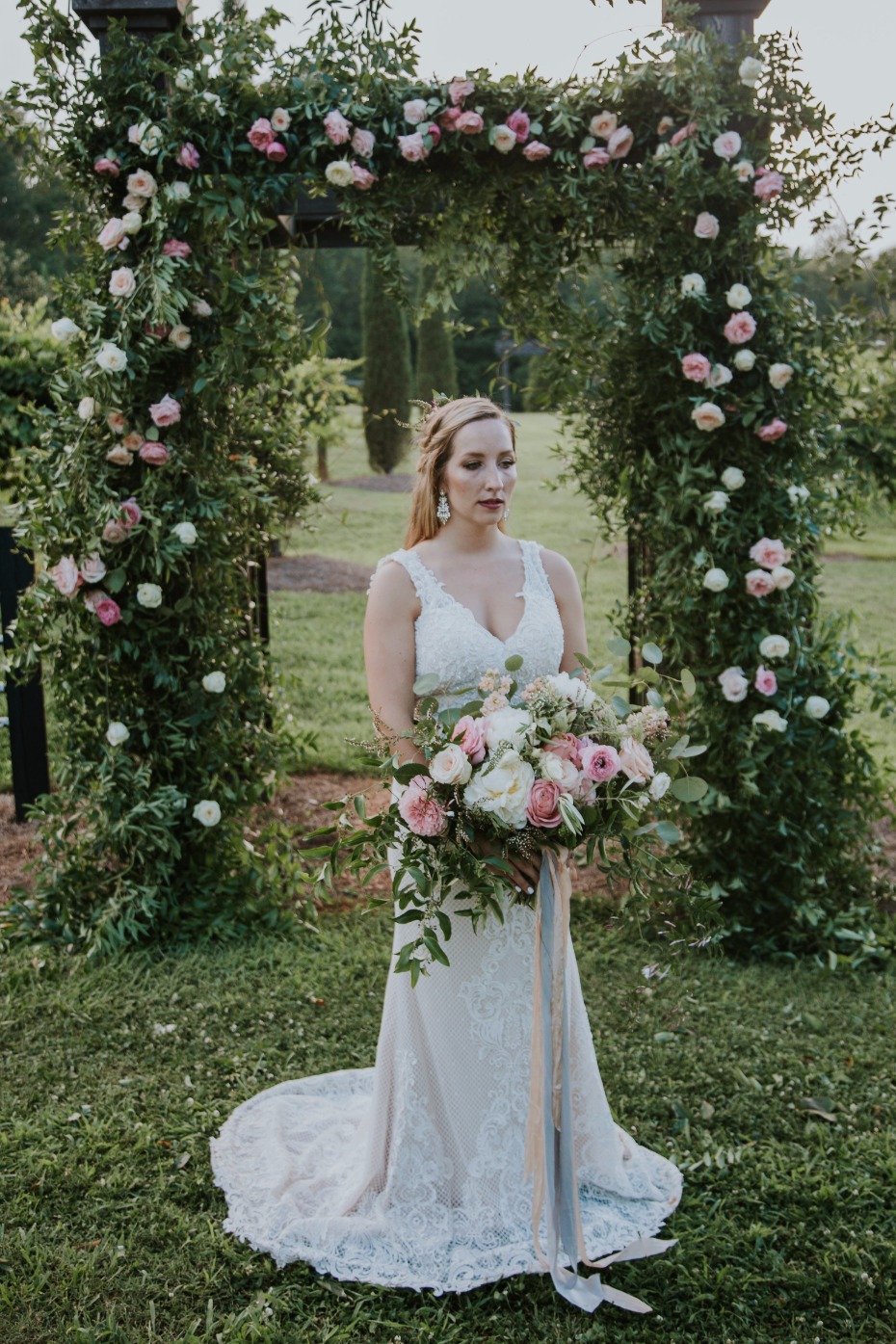 romantic rose covered wedding arch