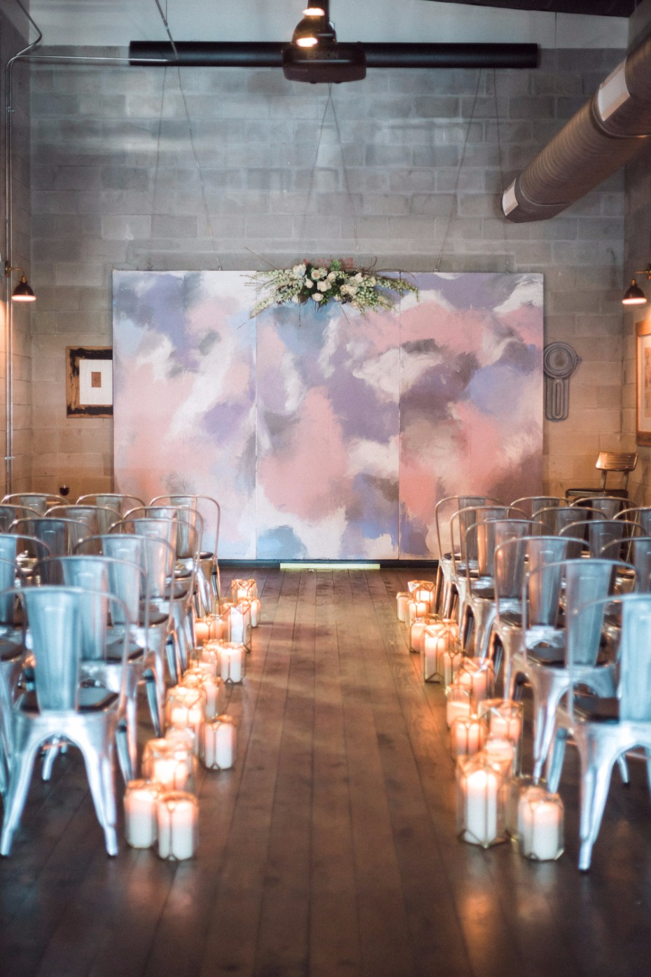 Wedding ceremony with candles and painted backdrop