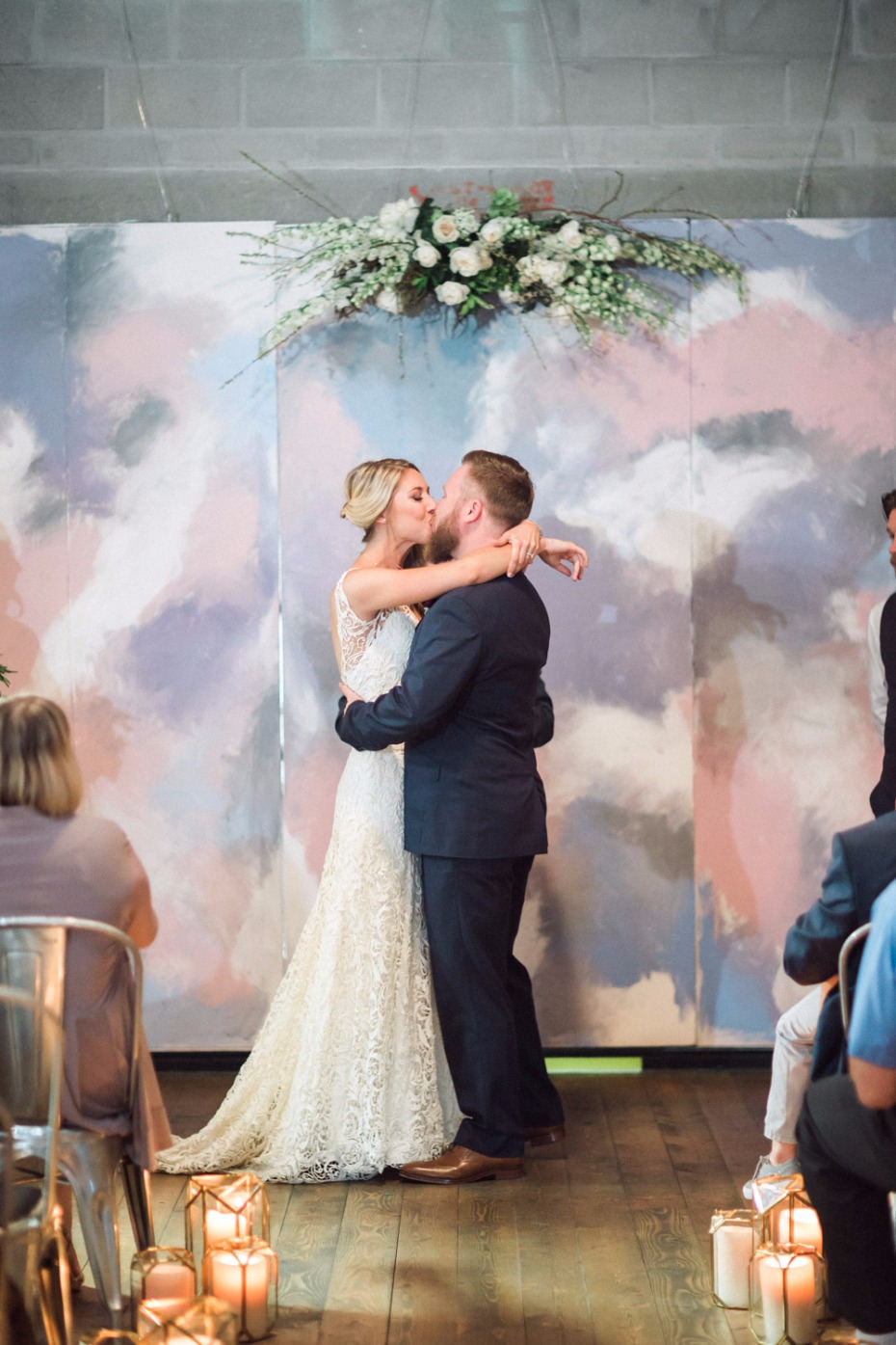 Bride and groom share a kiss at a wedding ceremony