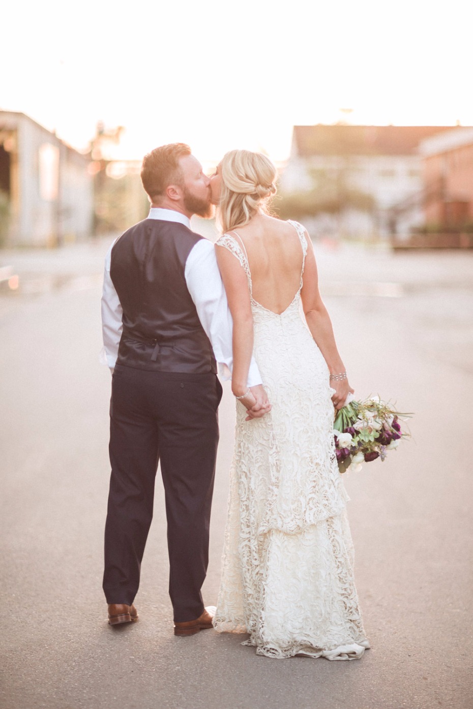 Romantic wedding kiss of the bride and groom on a sunny day