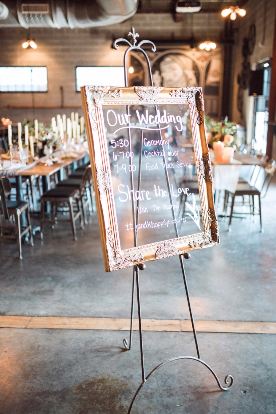 Elegant wedding schedule displayed on ornate gold frame