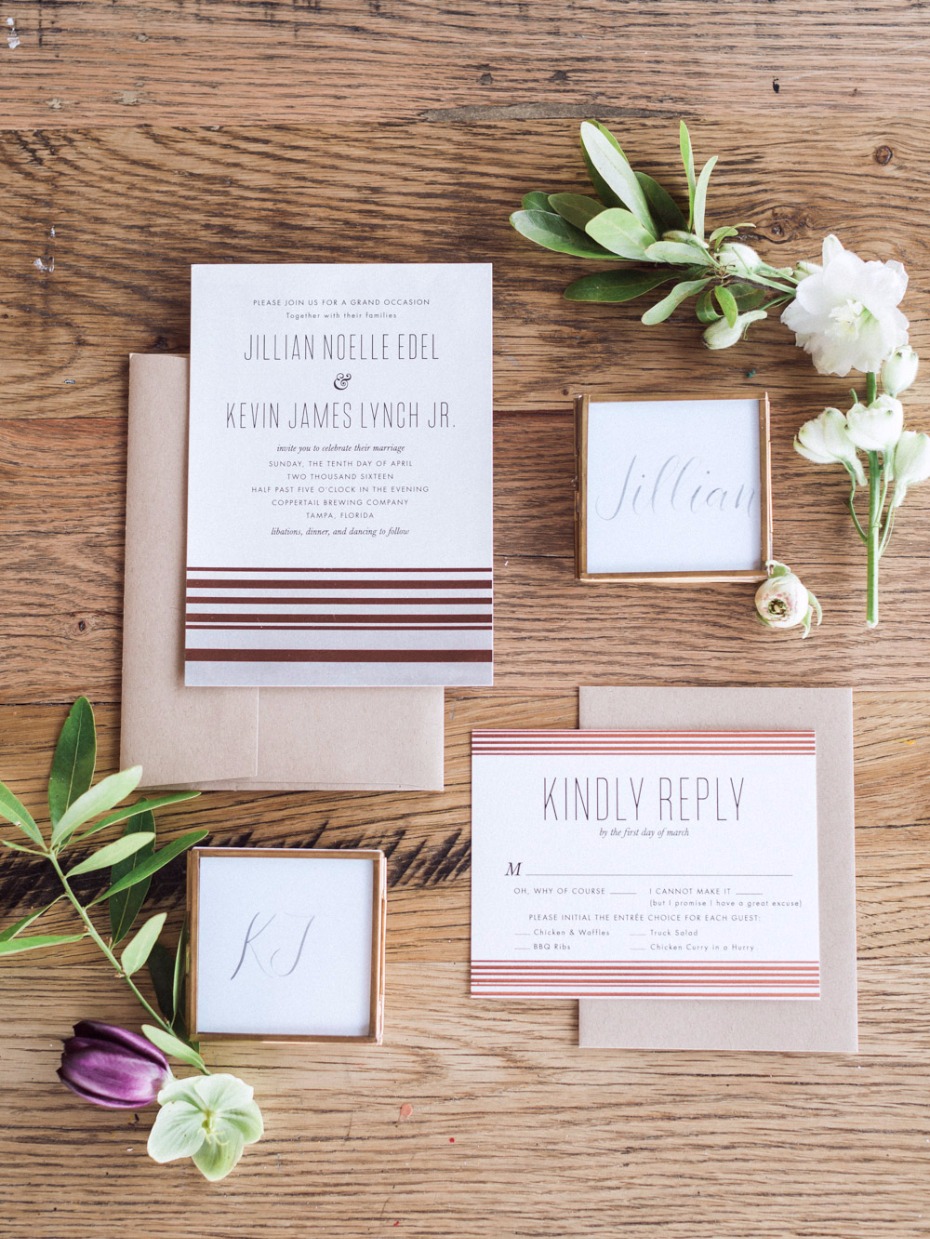Elegant wedding invitation suite on wood background
