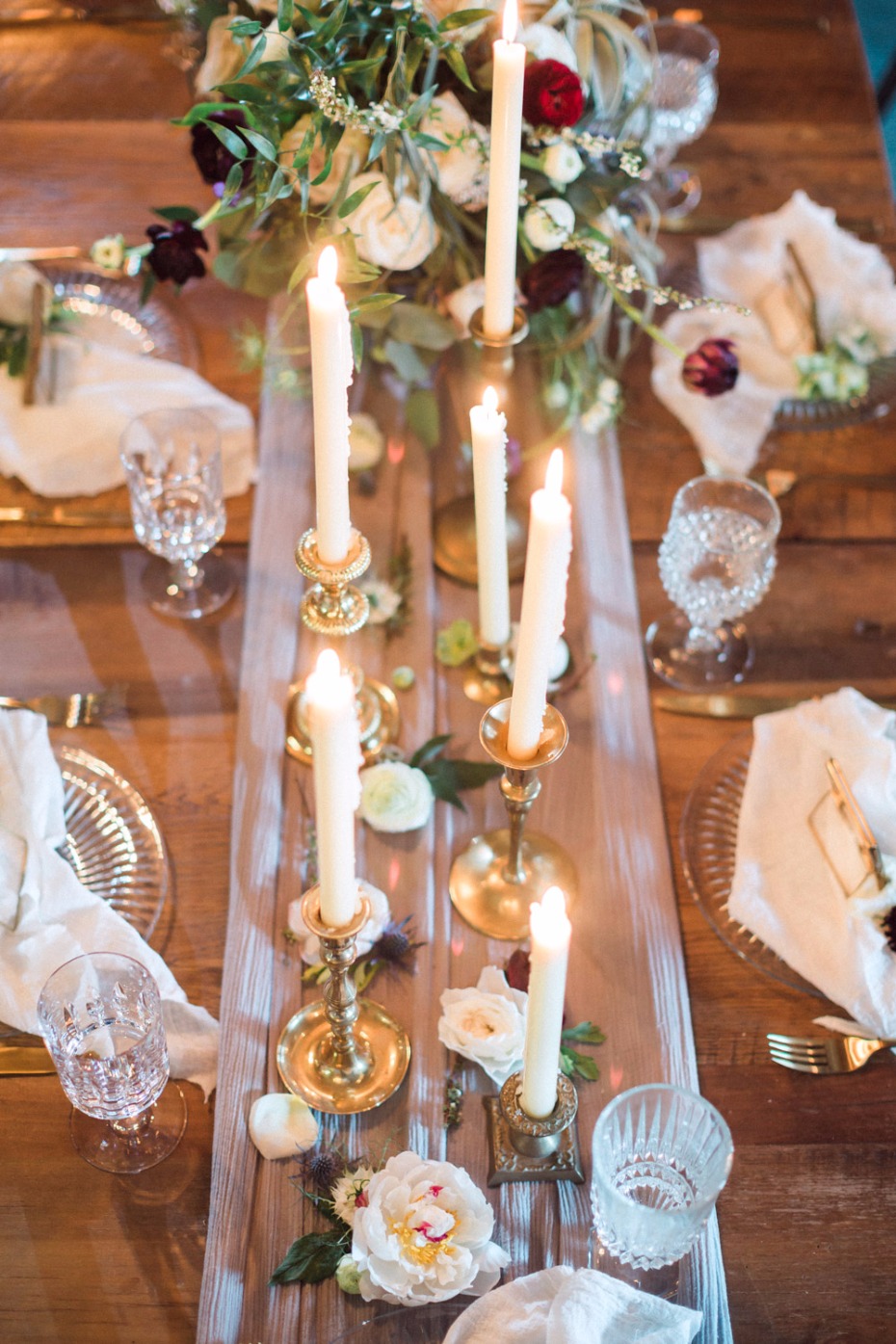 Elegant table setting with candles and floral arrangement