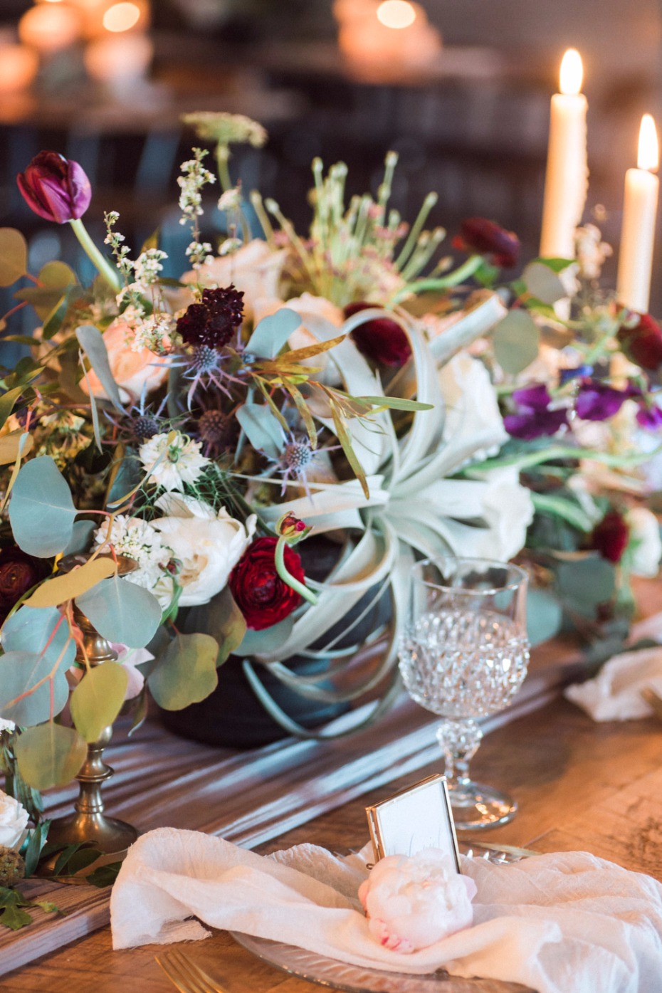 Elegant floral centerpiece with candles and romantic table setting