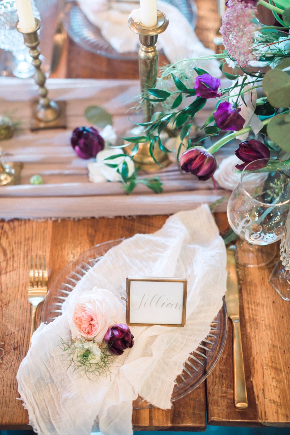 Elegant table setting with flowers, name card, and candles
