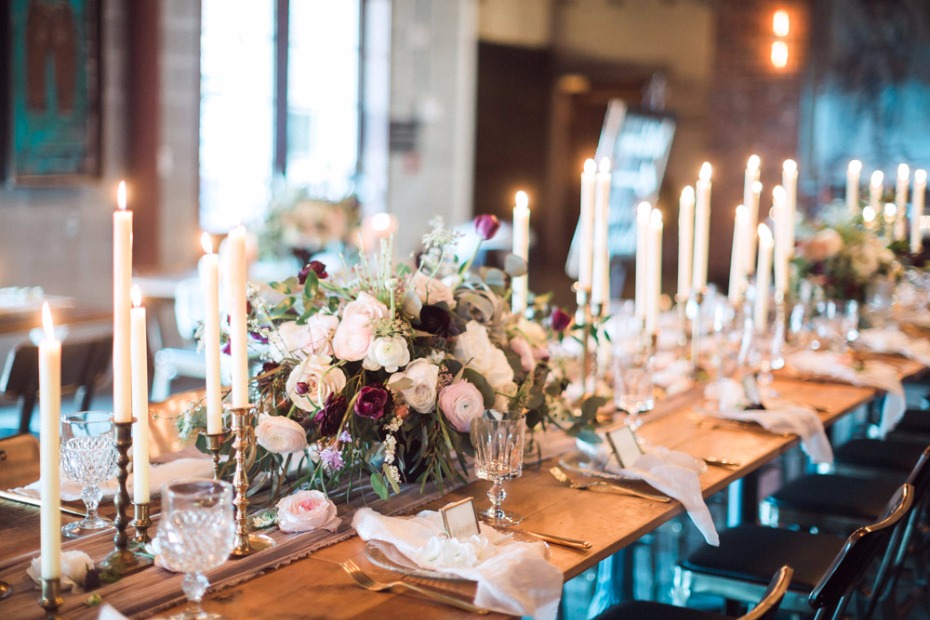 Elegant wedding table setting with candles and floral centerpiece