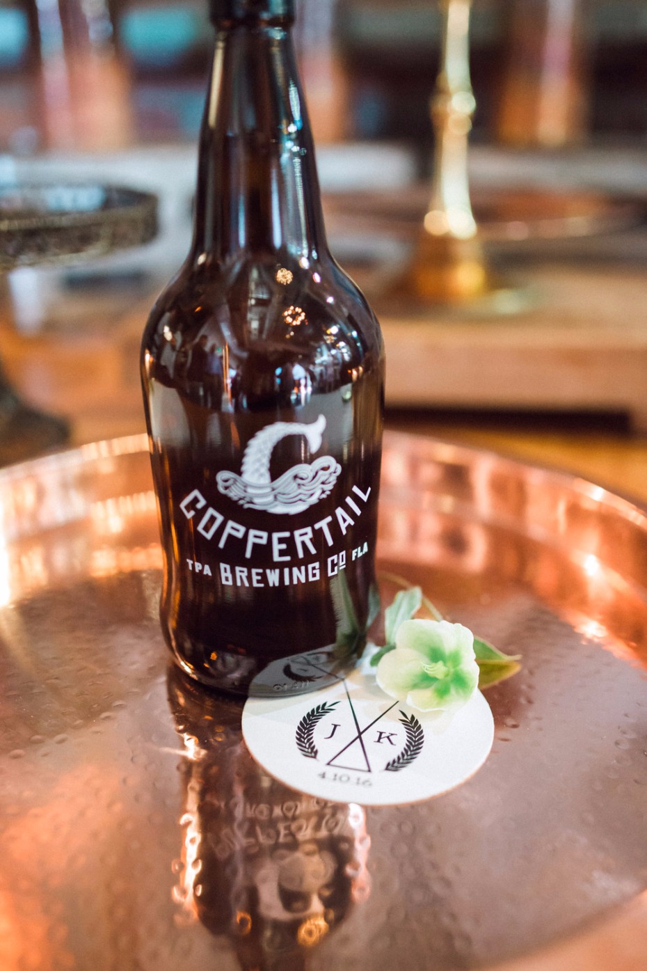 Coppertail IPA beer bottle with wedding initials on a copper tray