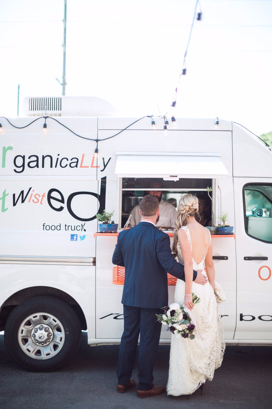 Bride and groom at food truck on their wedding day