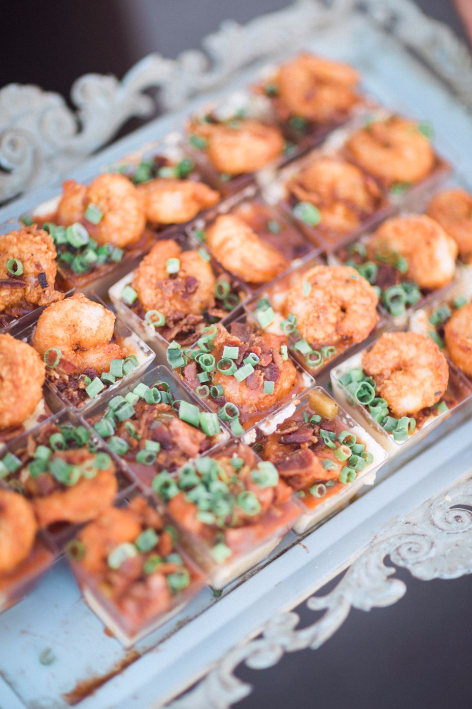 Miniature shrimp appetizers with green onions on a serving tray