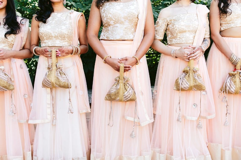 Blush and gold bridesmaid dresses with custom purses