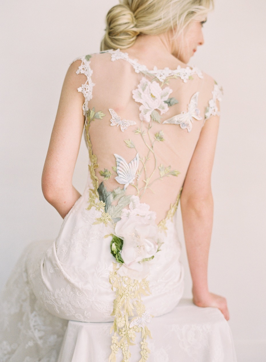 Woman in backless wedding dress with floral butterfly details