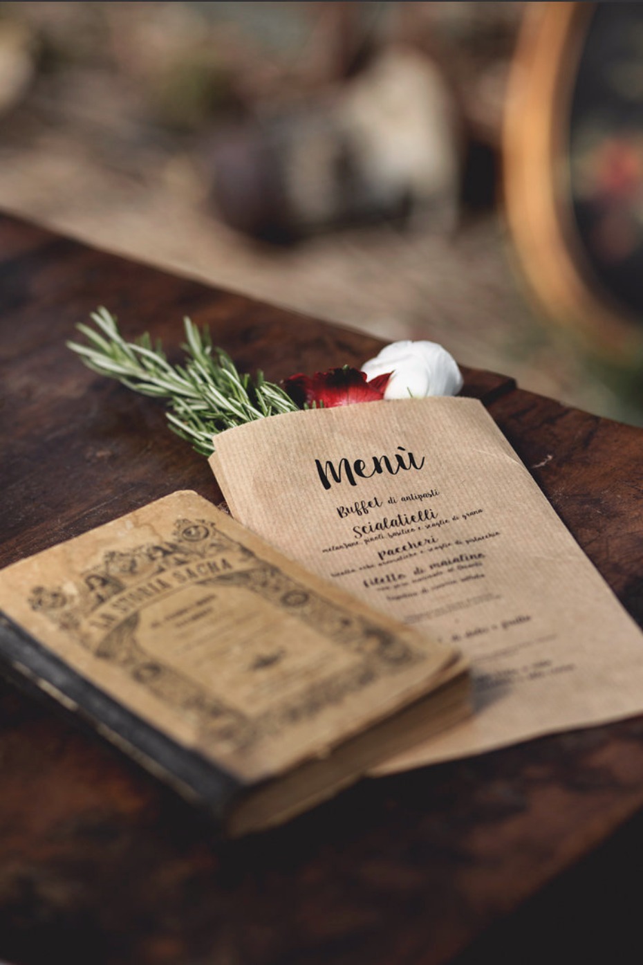 Vintage menu book with rosemary and garlic on wood