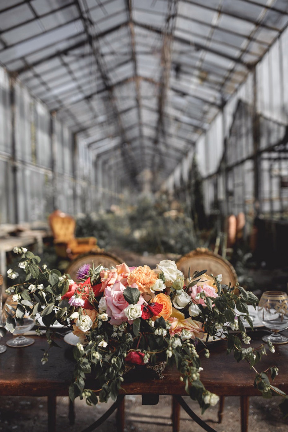 Floral centerpiece in an abandoned greenhouse setting