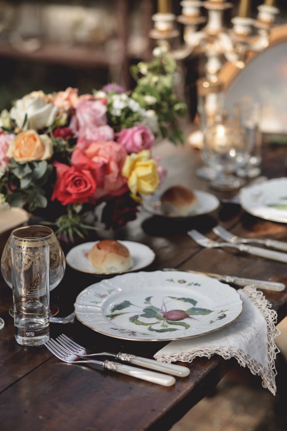 Elegant dinner table setting with flowers and tableware