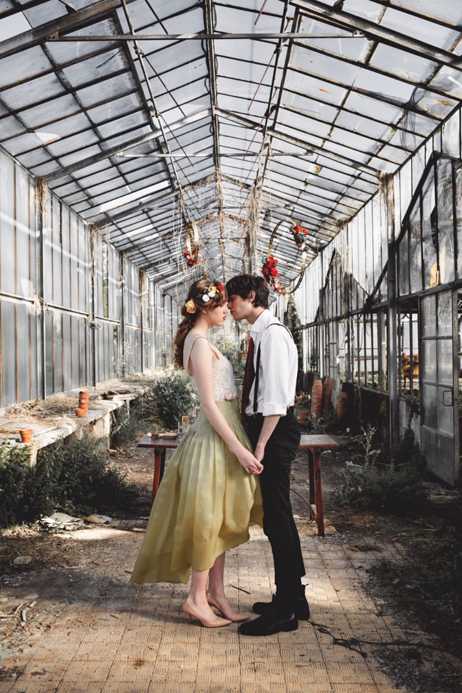 Couple sharing a tender moment in a vintage greenhouse