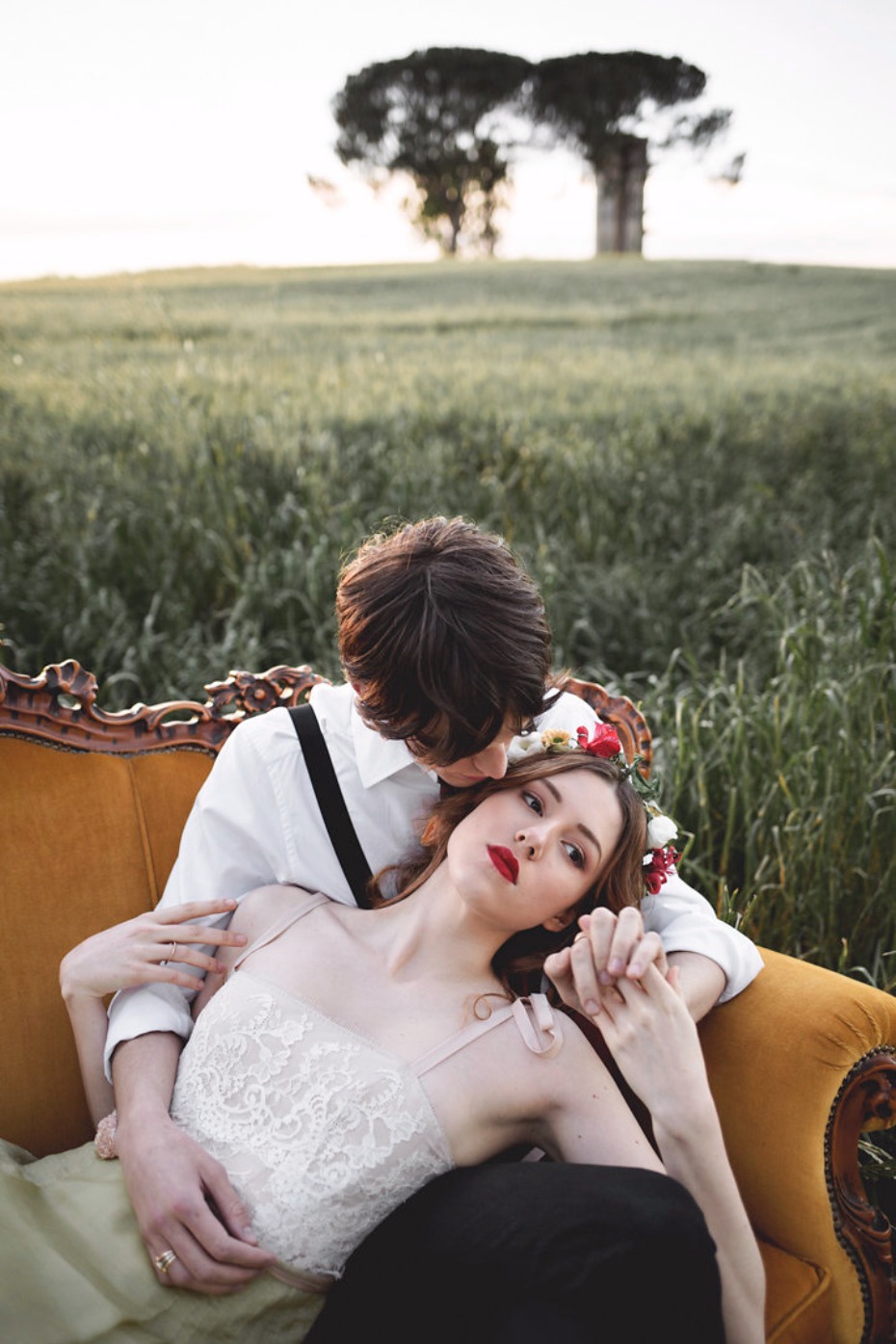 Romantic couple on a couch in a field, wedding photo