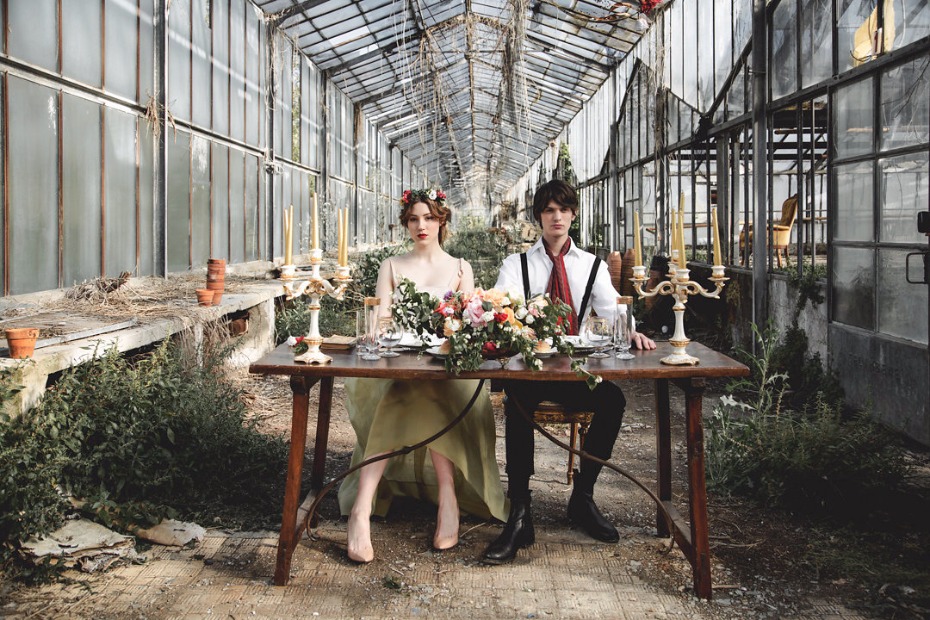 Couple in antique greenhouse enjoy romantic dinner setting