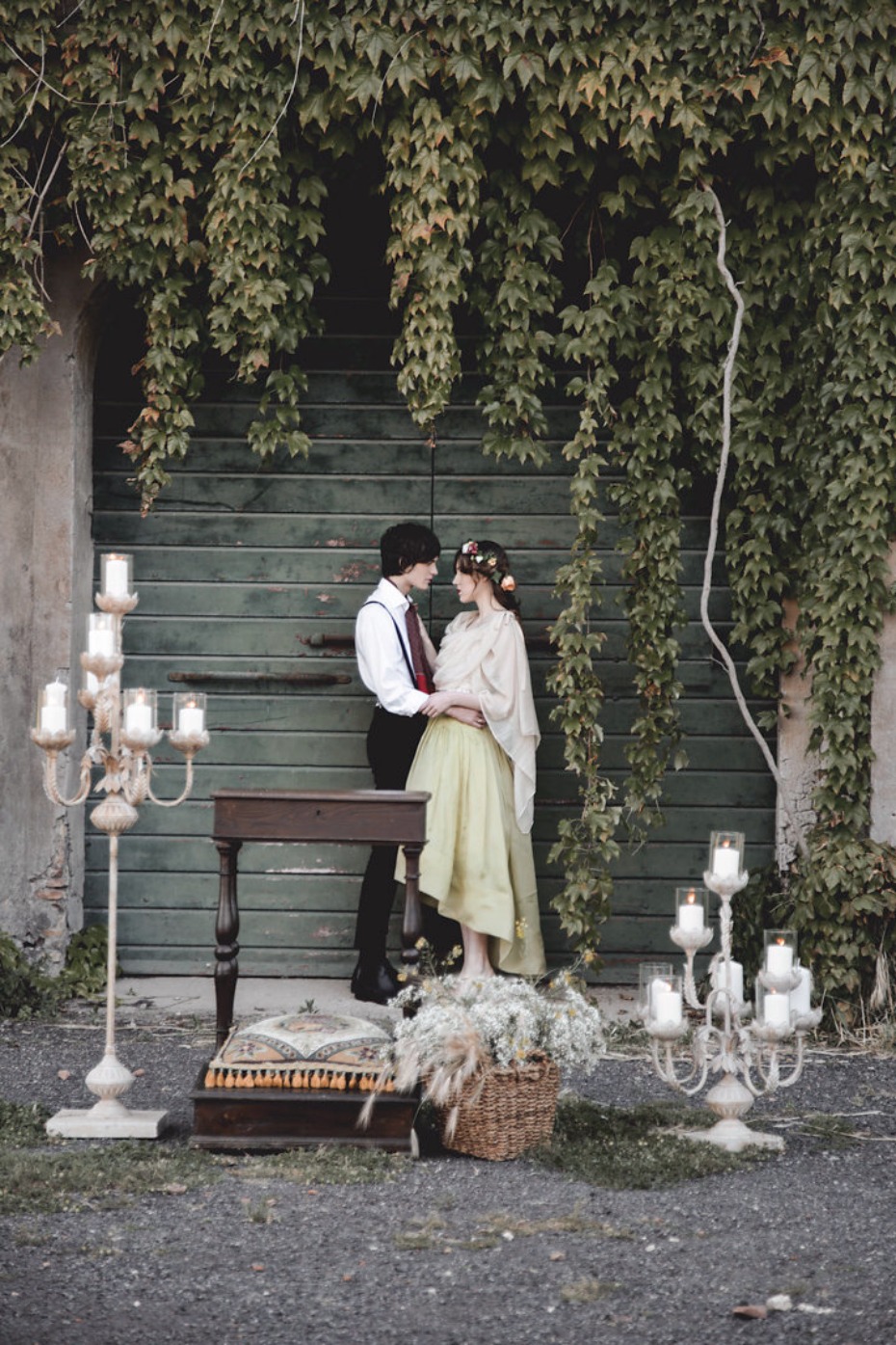 Romantic couple poses for wedding photo by ivy wall