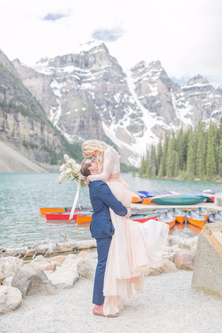 Bride and Groom embrace, mountain backdrop, wedding photo