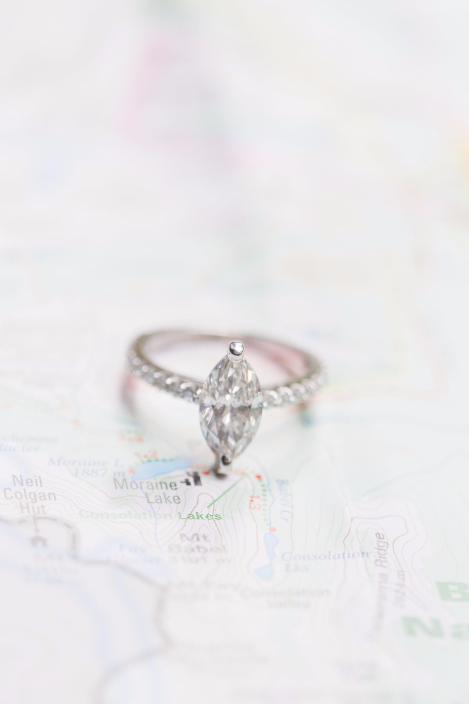 Marquise diamond engagement ring on a map background